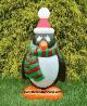 Penguin Wearing a Green and Red Scarf